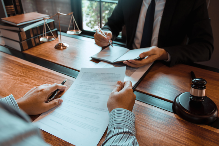 Lawyer in his office providing information to client - what should you ask a car accident lawyer at the consultation?