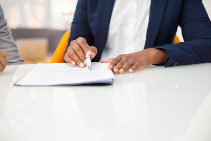 woman signing a document - can you sue a trust for personal injury?