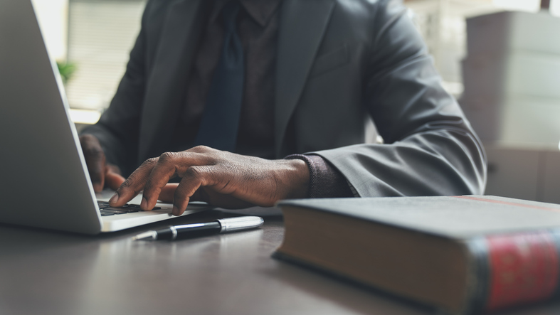 lawyer using laptop - can a personal injury case be reopened?