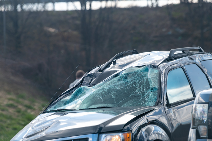 Closeup of damaged vehicle caused by a car wreck - what age group causes the most car accidents?