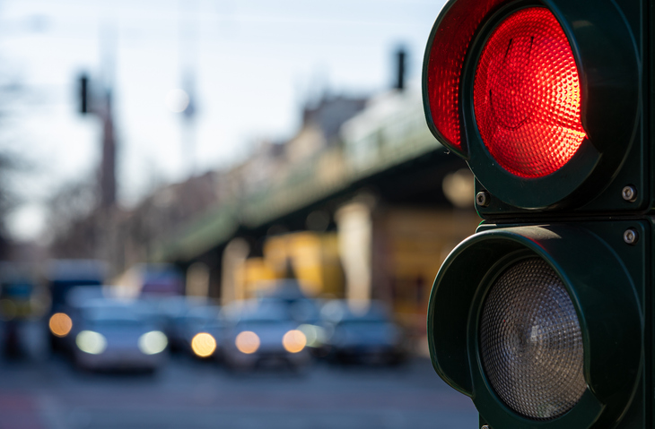 closeup of red light traffic signal at an intersection - What percentage of car accidents is caused by human errors?