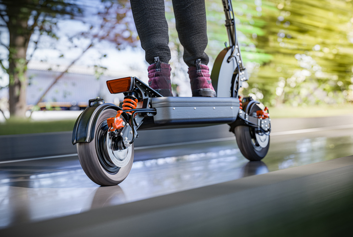Closeup of a rider on an electric scooter in motion - denver e-scooter accident attorney